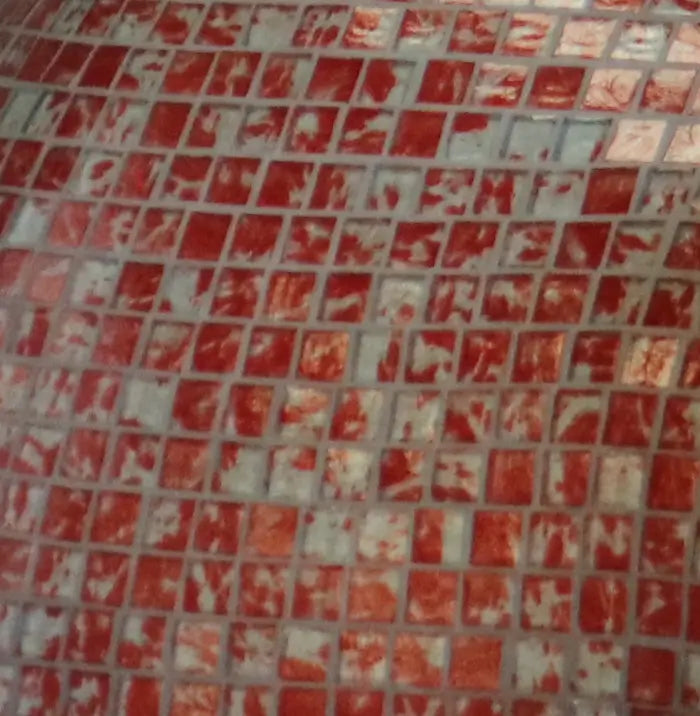 Close up of custom color glass mosaic tile on an HPC Fire Forno dome, scarlet and gray blend