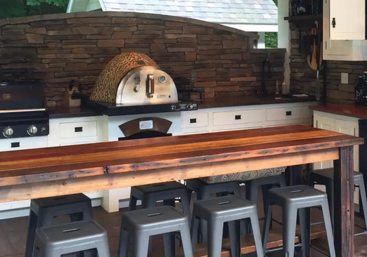 HPC Fire dual fuel pizza oven built into a stone outdoor kitchen