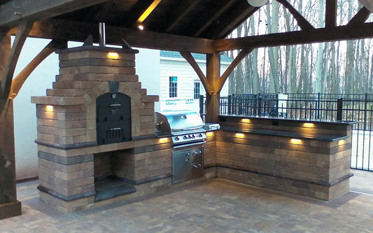 Tuscan Chef pizza oven built into a brick outdoor kitchen under a covered patio