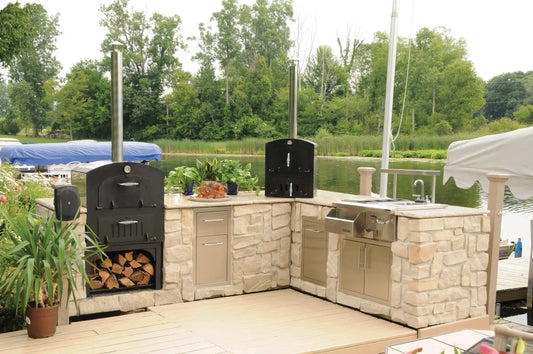 How much does an outdoor pizza oven cost: built-in pizza ovens in a stone outdoor kitchen beside the water