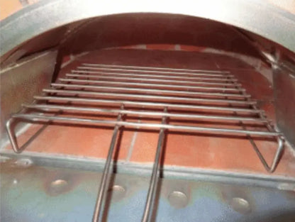 Authentic Pizza Ovens BBQ grill rack standing on the floor of a wood fired brick pizza oven with the door open