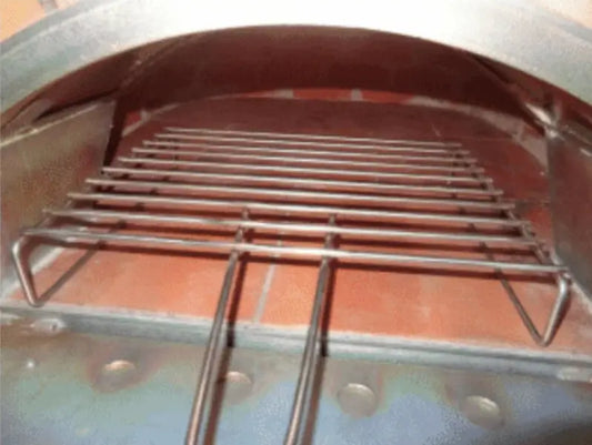Authentic Pizza Ovens BBQ grill rack standing on the floor of a wood fired brick pizza oven with the door open