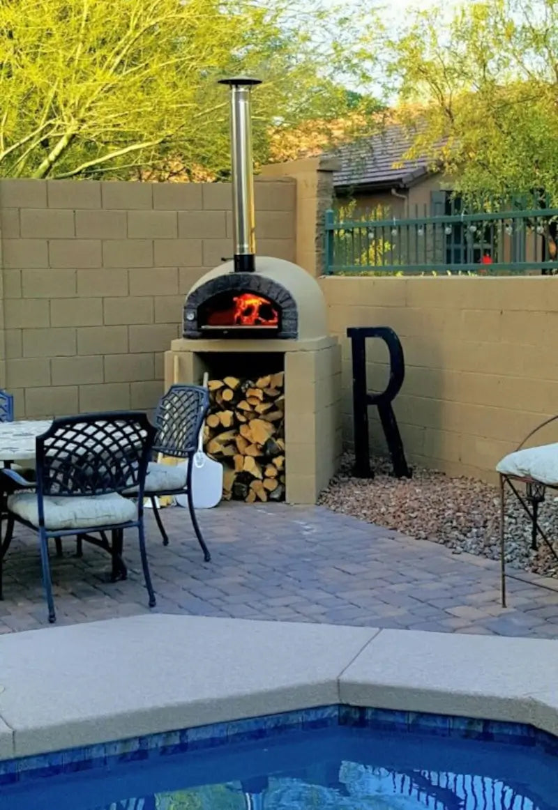 38 inch chimney extension and cap on a stucco finished Authentic Pizza Ovens brick oven beside a pool