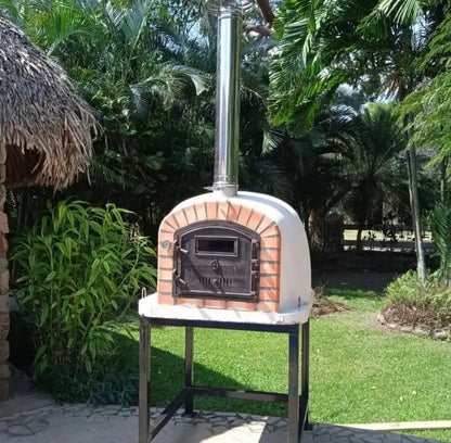 Lisboa Premium pizza oven with a stainless chimney extension pipe on a steel stand in a garden