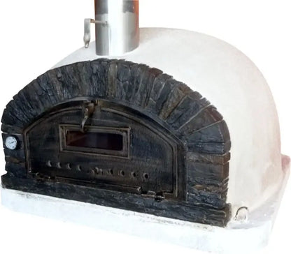 Buena Ventura Preto pizza oven from the side showing the low white dome behind the black stacked stone arch