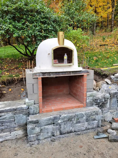 Builders custom Lisboa dome set on a fresh block and brick base with rebar showing, before the stone cladding goes on