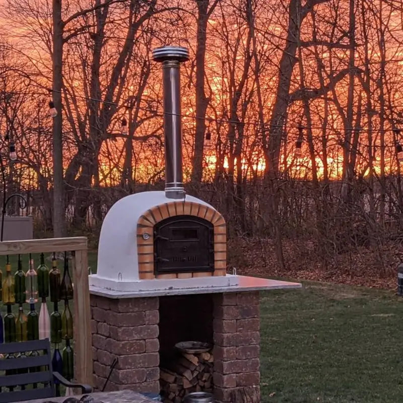 Lisboa Premium on a paver base at sunset with wood stored underneath