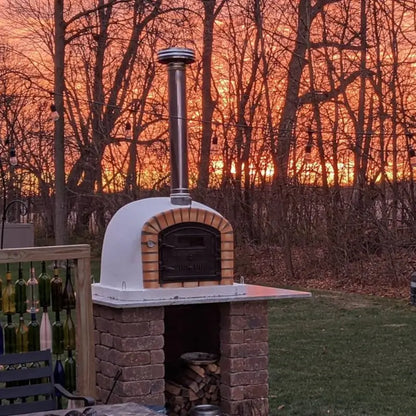 Lisboa Premium on a paver base at sunset with wood stored underneath