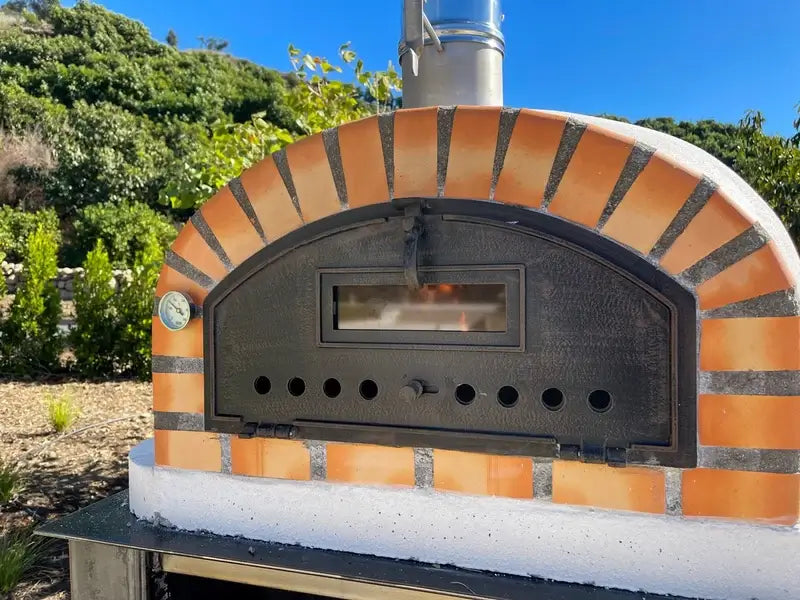 Close up of the Pizzaioli Premium black cast aluminum door, viewing window and thermometer