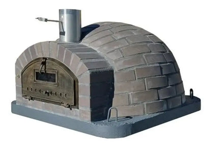 Lume Largo Tudo pizza oven with gray cast stone brick pattern cladding over the full low dome, viewing window door, and stainless chimney spout