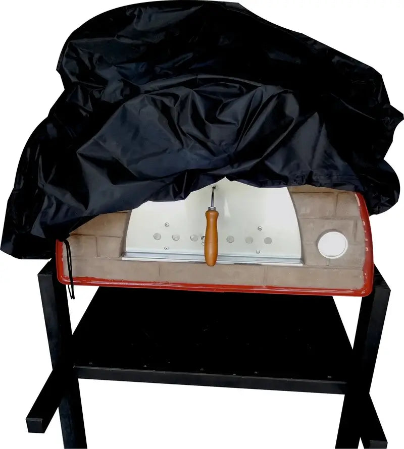 Authentic Pizza Ovens cover for the Maximus Mobile pizza oven being pulled over a red Maximus on a stand, showing the black PVC backed fabric and the drawstring hem