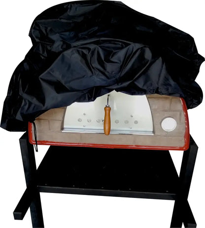 Authentic Pizza Ovens cover for the Maximus Mobile pizza oven being pulled over a red Maximus on a stand, showing the black PVC backed fabric and the drawstring hem