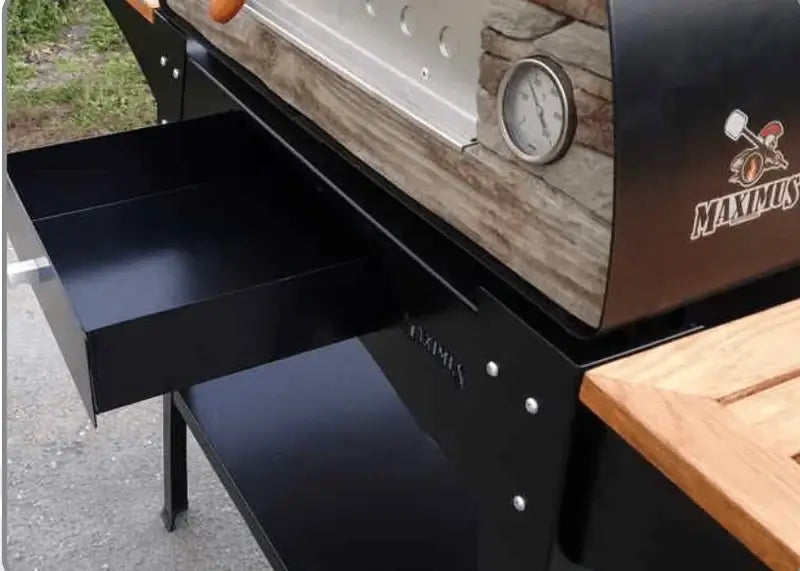 Close up of the pull out steel tool drawer under the oven on the Maximus Mobile Woody stand, with the wood slat shelf beside it