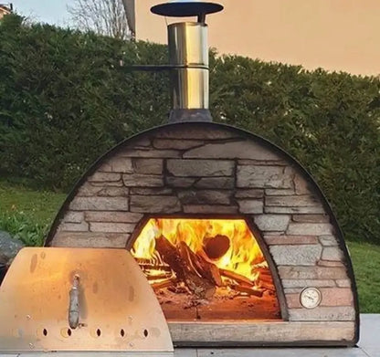 Black Maximus Prime pizza oven with the stainless door set aside and a full wood fire burning across the tile floor