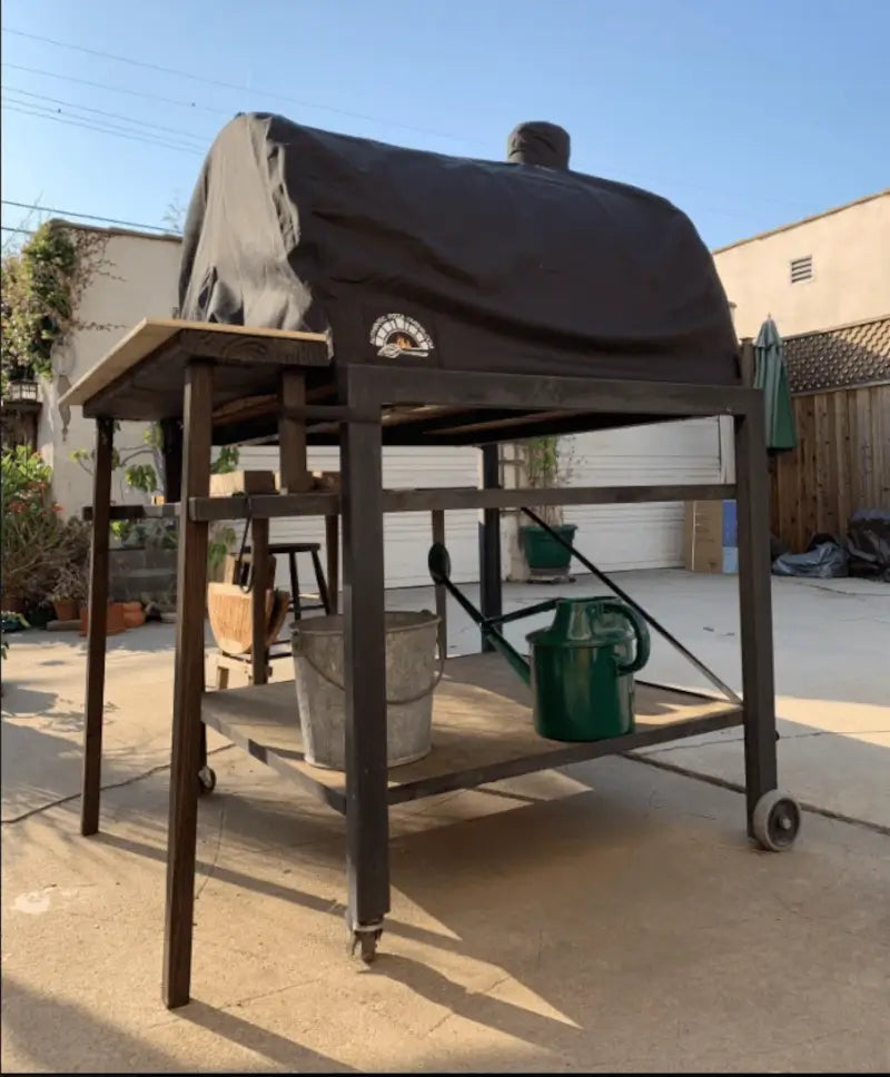 Maximus Prime pizza oven cover on a Prime mounted on a homemade steel and timber cart in a backyard