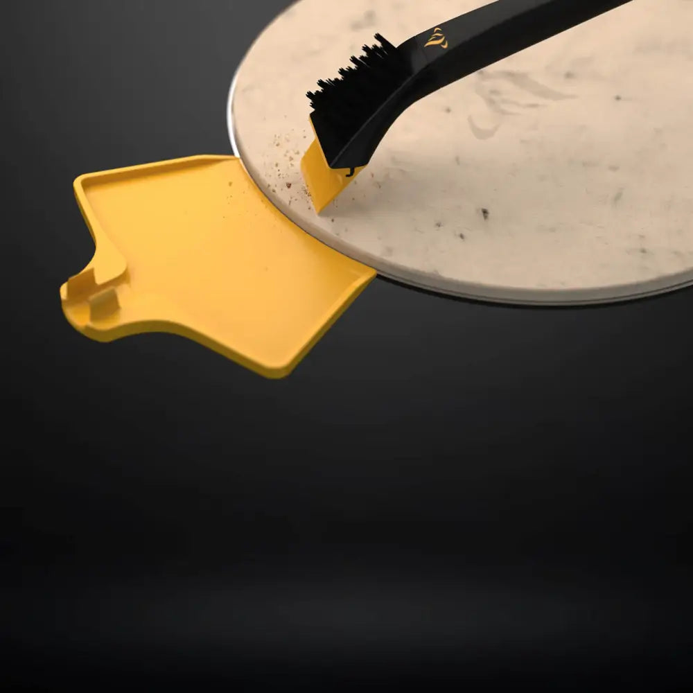 Removable scraper tip of the Halo Pizza Stone Cleaning Kit lifting baked-on debris from the pizza stone