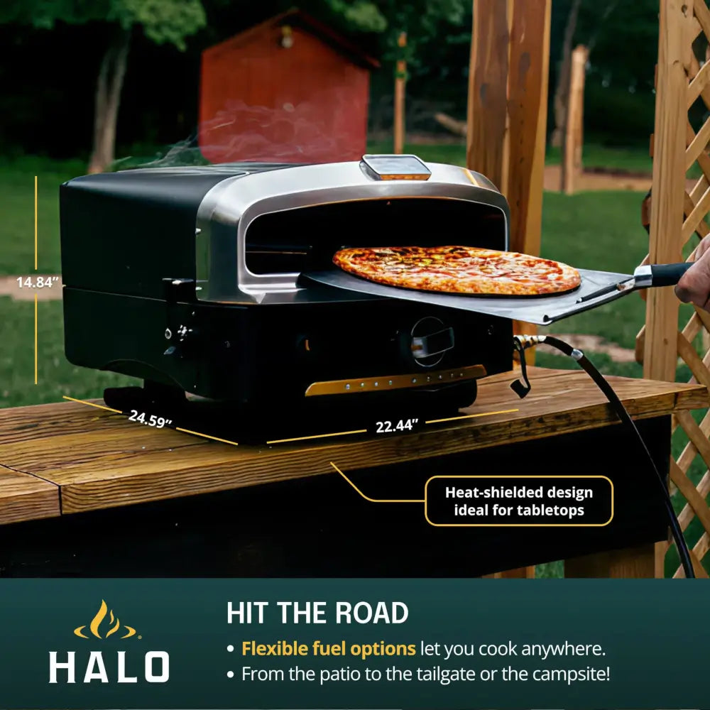 Halo Versa 16 pizza oven dimensions 22.44 by 24.59 by 14.84 inches on an outdoor table