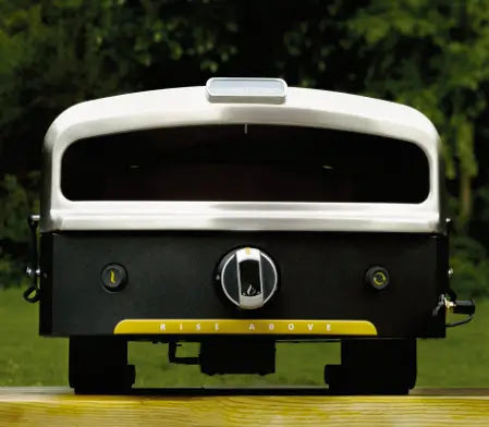 Halo Versa 16 outdoor pizza oven front view with hood closed on a wooden table