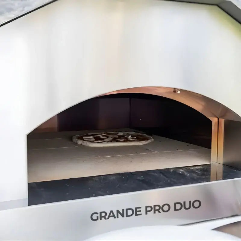 Inside the ItaliaForno Grande Pro Duo, refractory floor and copper toned dome with a pizza cooking